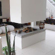 A modern looking fireplace in the center of a room